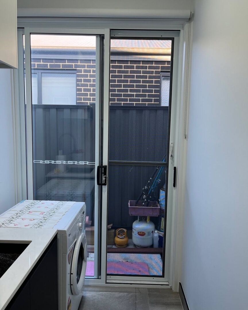 Fly wire sliding door on a laundry