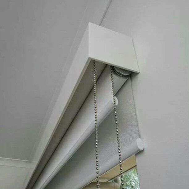 Close-up of a white pelmet box concealing a roller blind